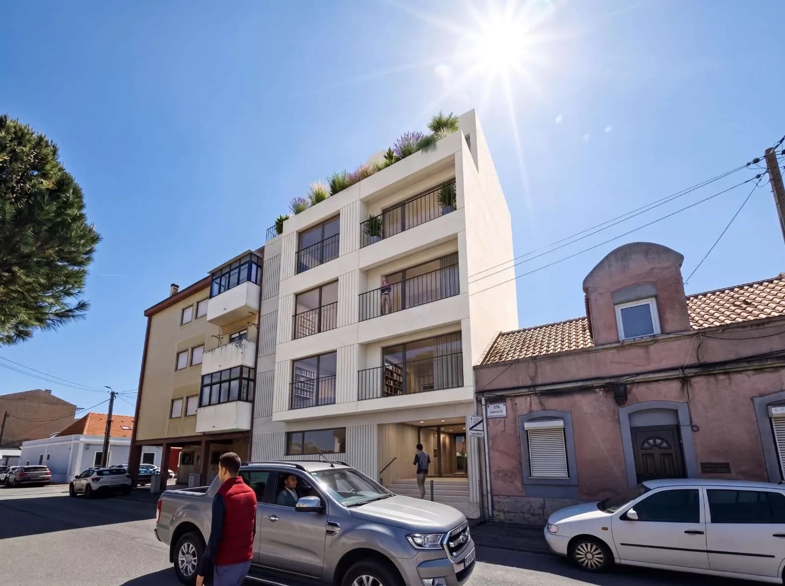 Street-level render of the Arena building in Barreiro with a light facade and rooftop planting